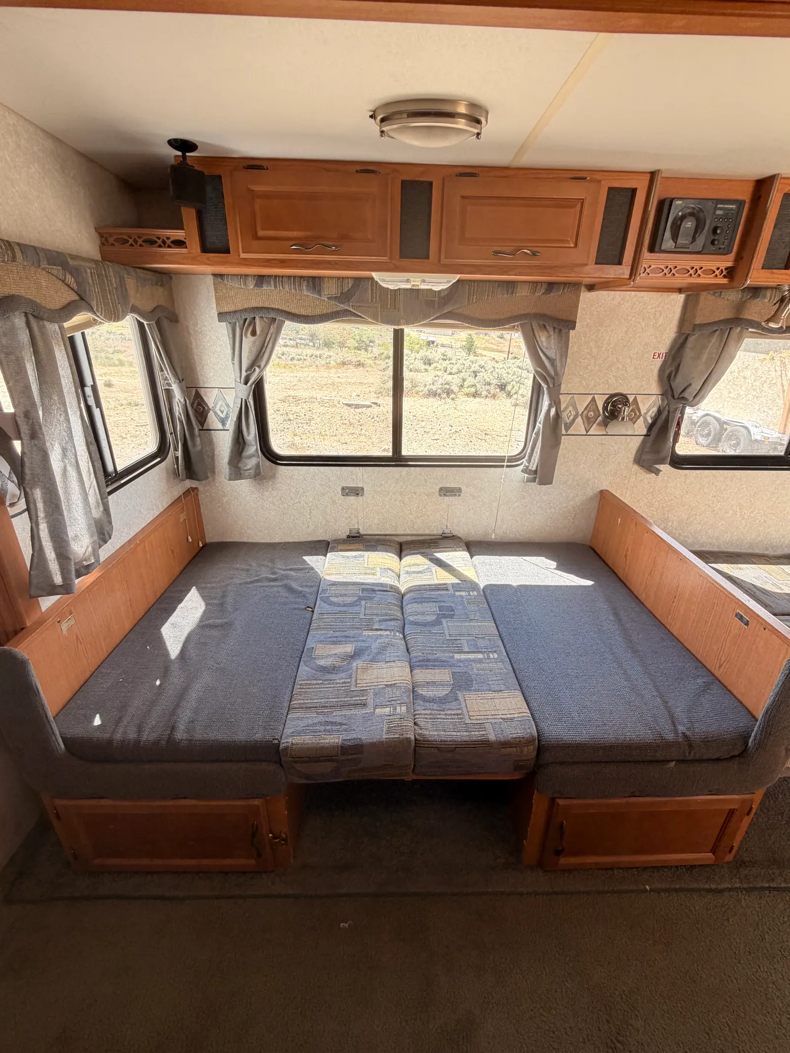 Fold-out sofa that converts to a bed, under two large windows